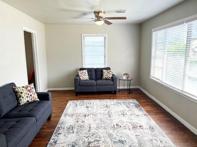 living room with plenty of natural light, dark hardwood / wood-style floors, and ceiling fan