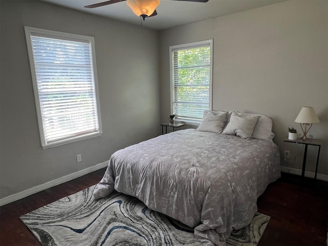 bedroom with ceiling fan and dark hardwood / wood-style floors