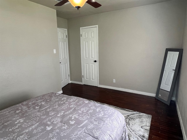 unfurnished bedroom featuring ceiling fan and dark hardwood / wood-style flooring