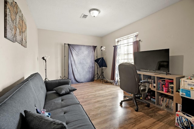 home office with hardwood / wood-style flooring