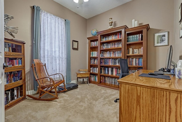 carpeted office featuring ceiling fan