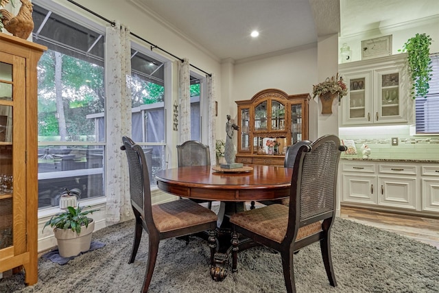 dining room featuring light hardwood / wood-style flooring and ornamental molding