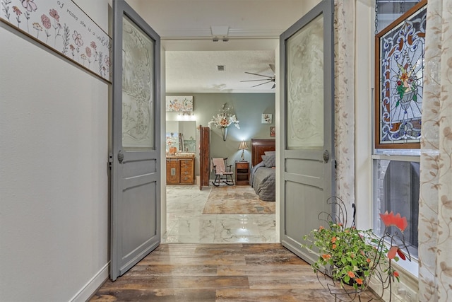 hall featuring hardwood / wood-style floors and a textured ceiling