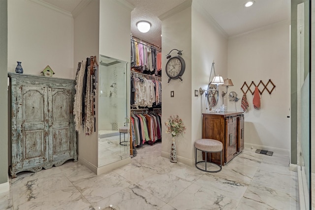 corridor with ornamental molding and a textured ceiling