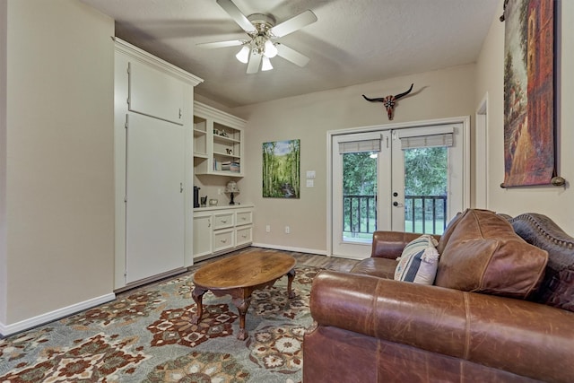 living room with ceiling fan, a textured ceiling, and french doors