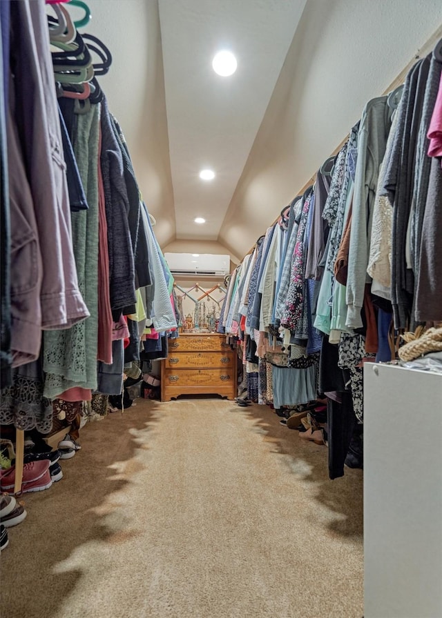 walk in closet featuring carpet floors, a wall mounted AC, and vaulted ceiling