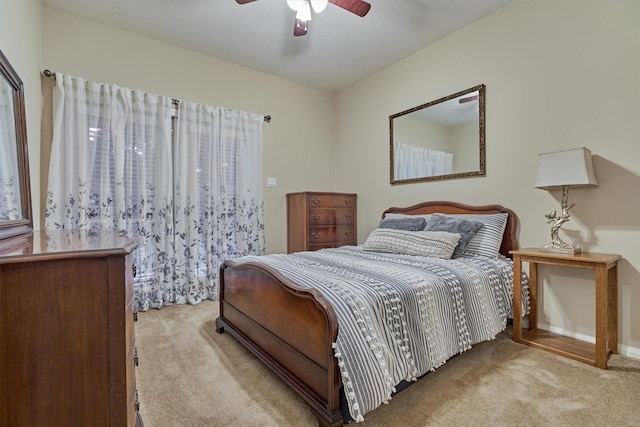 bedroom with ceiling fan and light carpet