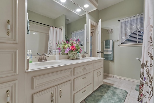 bathroom with tile patterned floors and vanity