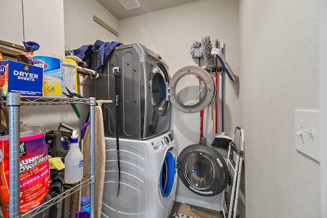 laundry area featuring stacked washer / drying machine