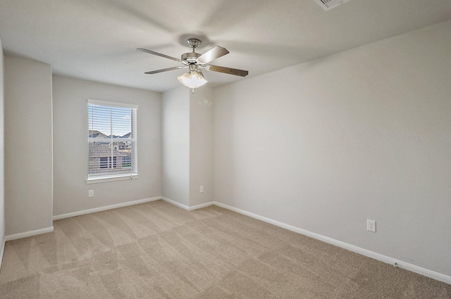 spare room with light carpet and ceiling fan