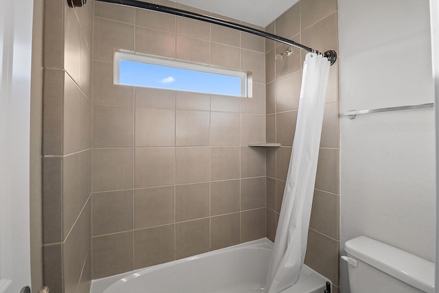 bathroom featuring shower / bath combo and toilet