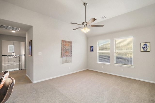 unfurnished room featuring light carpet, vaulted ceiling, and ceiling fan