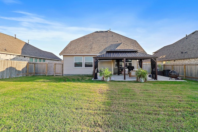 back of property featuring a gazebo, a yard, and a patio area