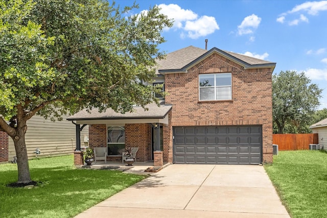 view of front of home with central air condition unit, a front lawn, and a garage