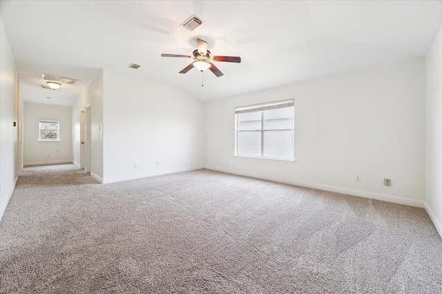 carpeted spare room with ceiling fan and lofted ceiling