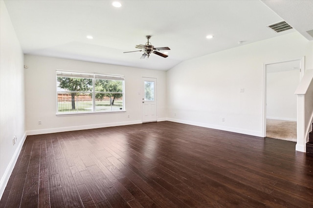 spare room with dark hardwood / wood-style flooring, vaulted ceiling, and ceiling fan