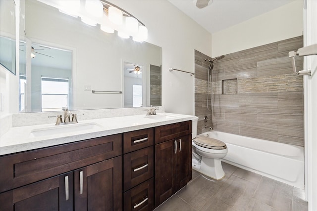 full bathroom with tiled shower / bath combo, toilet, and vanity