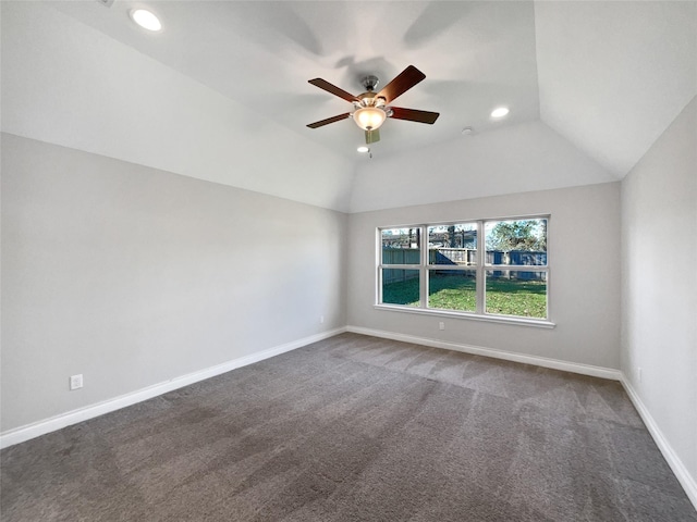 unfurnished room featuring ceiling fan, lofted ceiling, and dark colored carpet