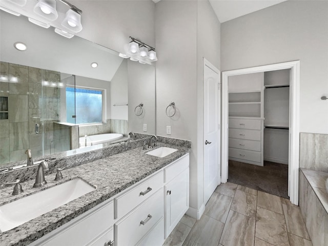 bathroom featuring vanity and separate shower and tub