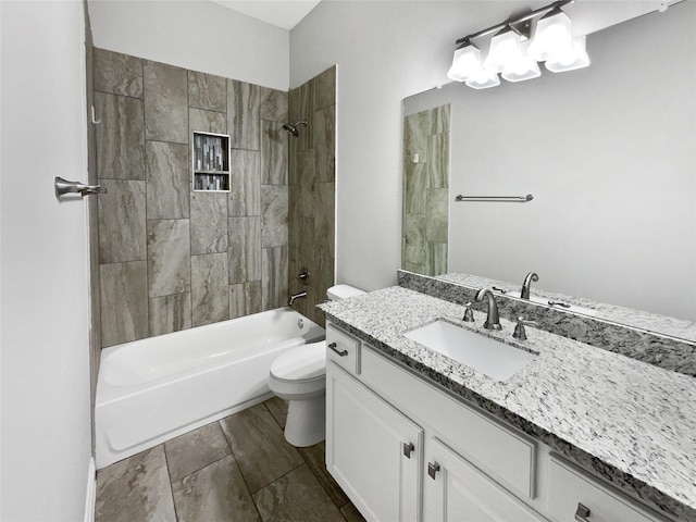 full bathroom featuring vanity, toilet, and tiled shower / bath