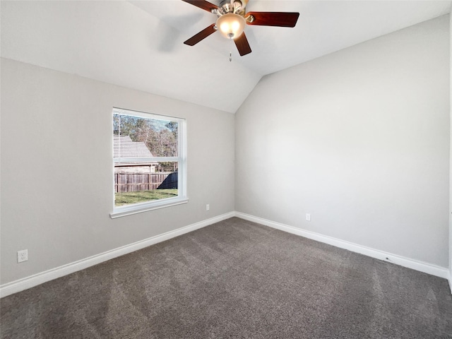 carpeted empty room with ceiling fan and vaulted ceiling