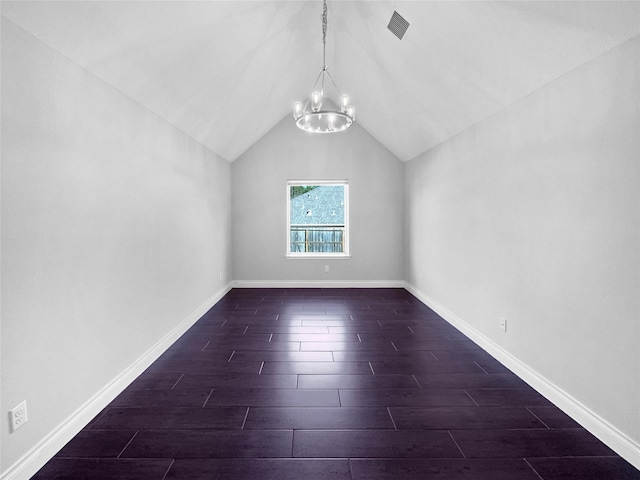 additional living space featuring a chandelier and vaulted ceiling