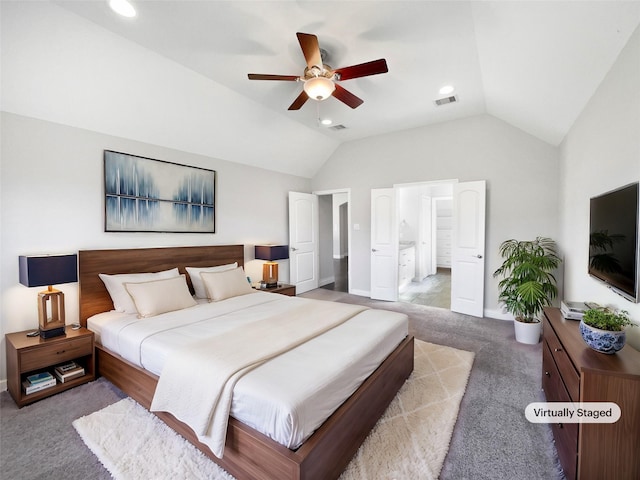 carpeted bedroom featuring ceiling fan, lofted ceiling, and connected bathroom