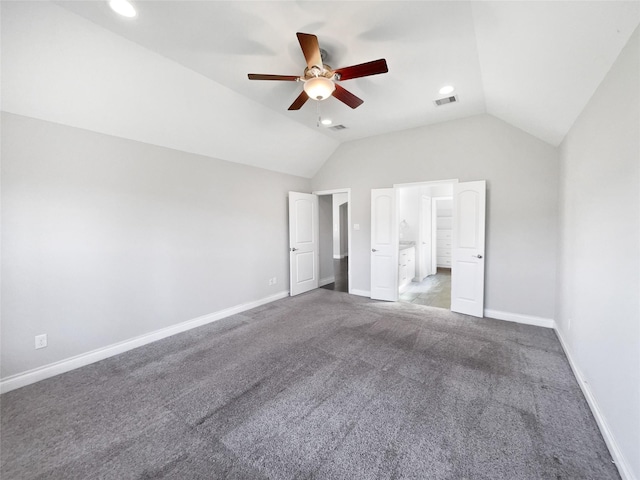 unfurnished bedroom featuring carpet flooring, ensuite bathroom, vaulted ceiling, and ceiling fan