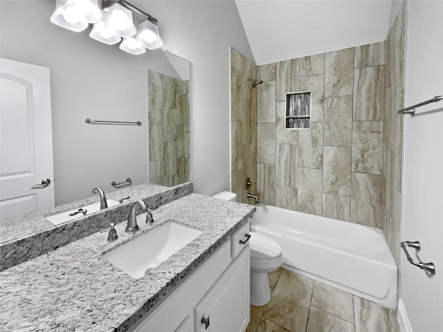 full bathroom with vanity, toilet, tiled shower / bath, and lofted ceiling