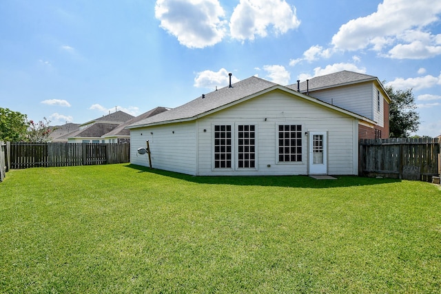 rear view of property featuring a yard