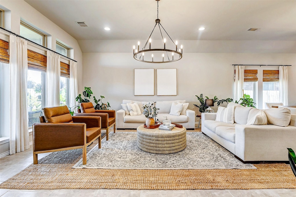 living room featuring plenty of natural light and an inviting chandelier