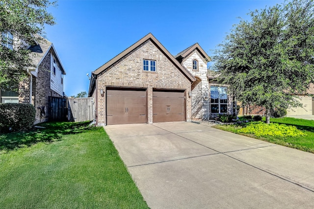 view of front of house with a front yard and a garage