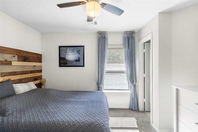 bedroom with ceiling fan and light colored carpet