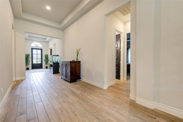 foyer entrance featuring a raised ceiling