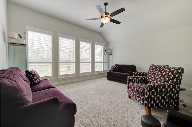 living room featuring ceiling fan, carpet floors, and vaulted ceiling