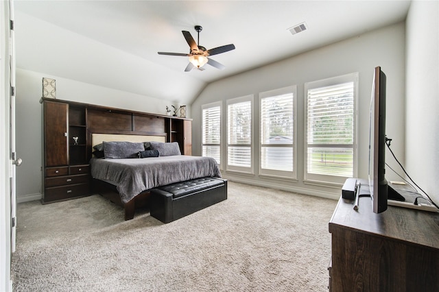 carpeted bedroom with multiple windows, ceiling fan, and lofted ceiling