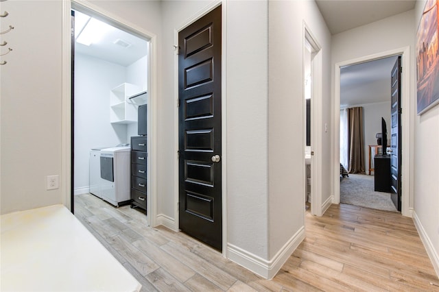 hall featuring washer and dryer and light wood-type flooring