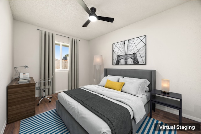 bedroom with ceiling fan, wood-type flooring, and a textured ceiling