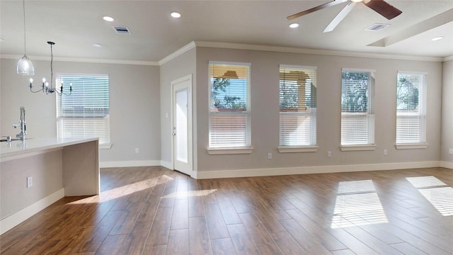 unfurnished dining area with plenty of natural light, ornamental molding, and sink