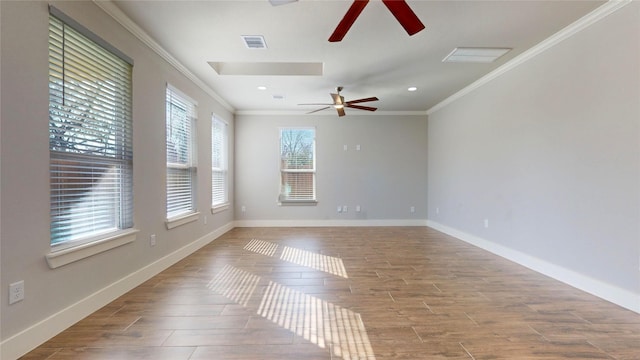 spare room featuring light hardwood / wood-style floors and crown molding