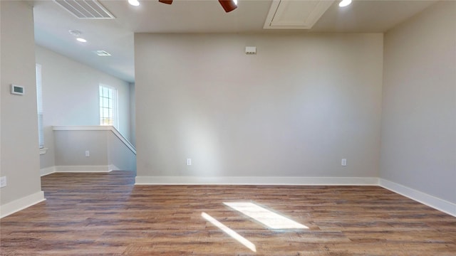 empty room with ceiling fan and dark wood-type flooring