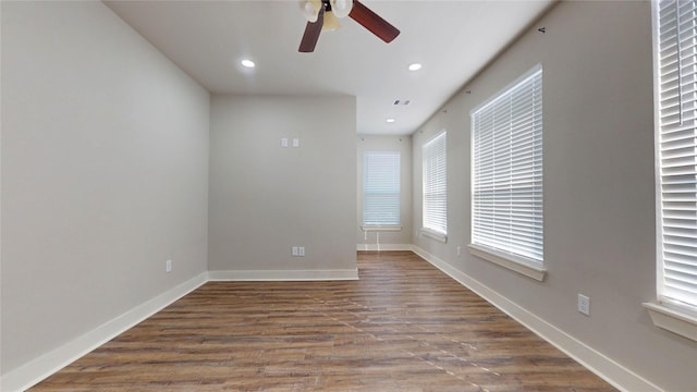 spare room featuring wood-type flooring and ceiling fan