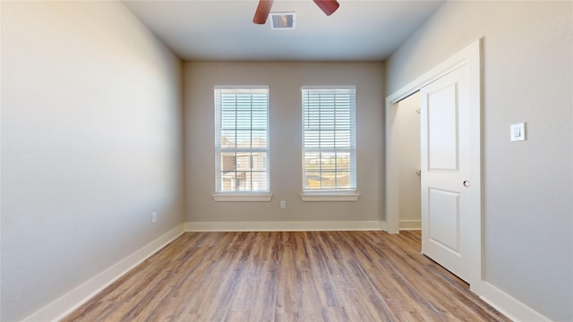 empty room with wood-type flooring and ceiling fan