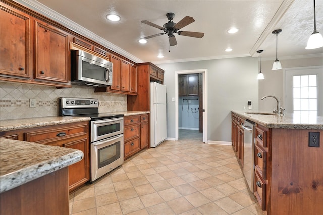 kitchen with appliances with stainless steel finishes, ornamental molding, ceiling fan, sink, and decorative light fixtures