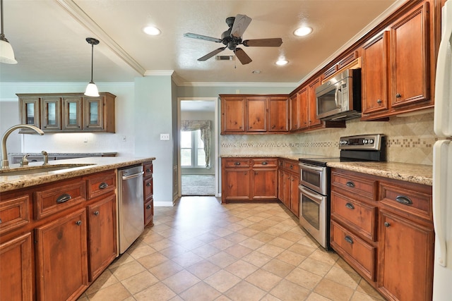 kitchen with ceiling fan, sink, light stone counters, decorative light fixtures, and appliances with stainless steel finishes