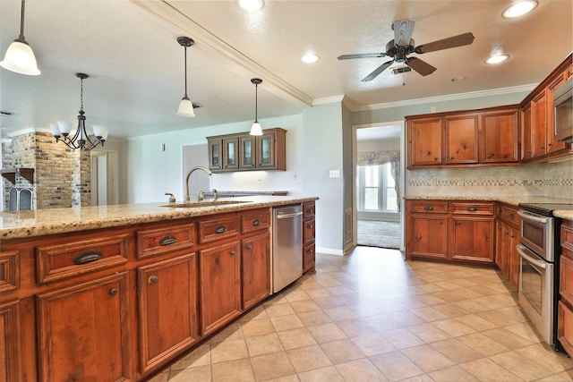 kitchen with light stone countertops, ceiling fan with notable chandelier, stainless steel appliances, sink, and decorative light fixtures