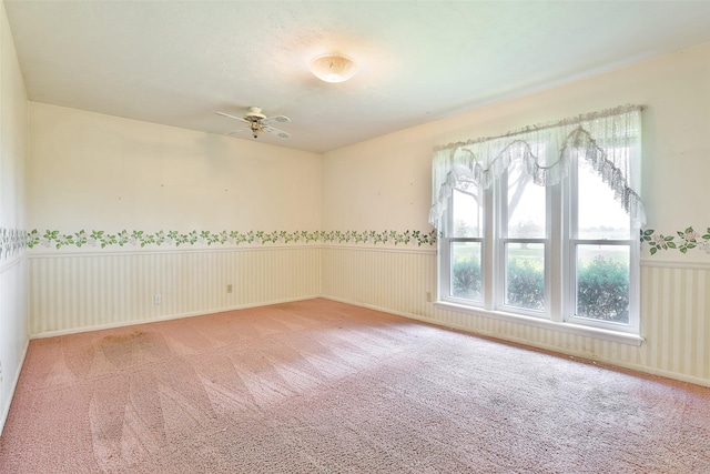 carpeted empty room featuring ceiling fan