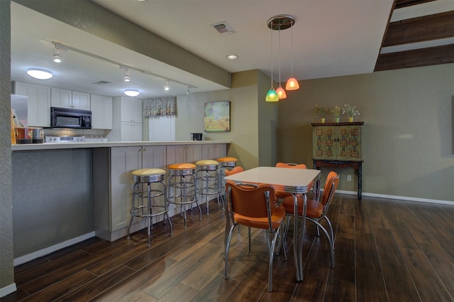 dining room featuring track lighting