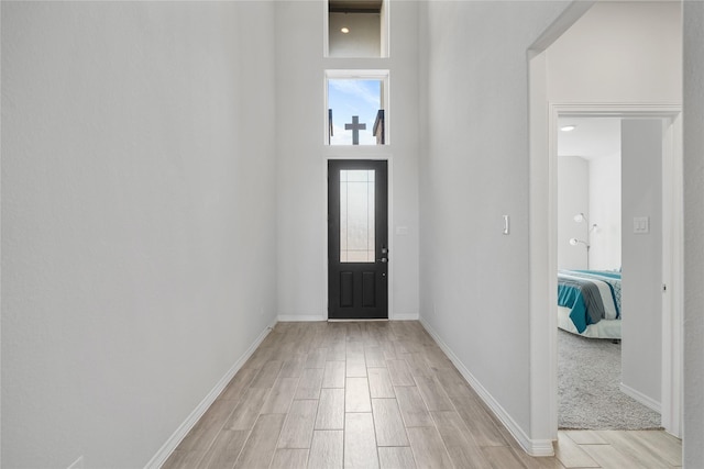 foyer entrance featuring a towering ceiling