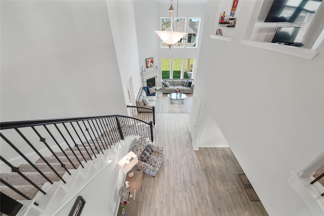 stairs featuring hardwood / wood-style flooring and a high ceiling